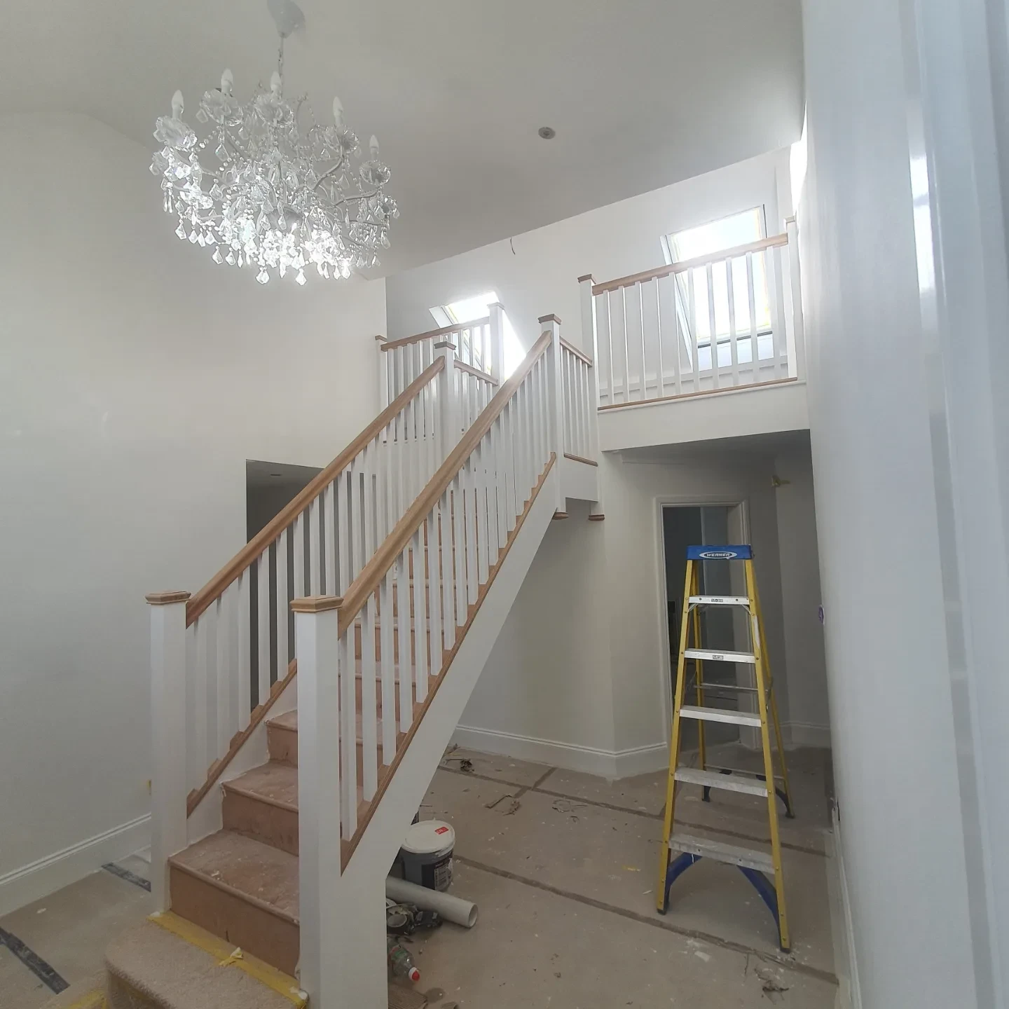 Large double-height staircase and chandelier