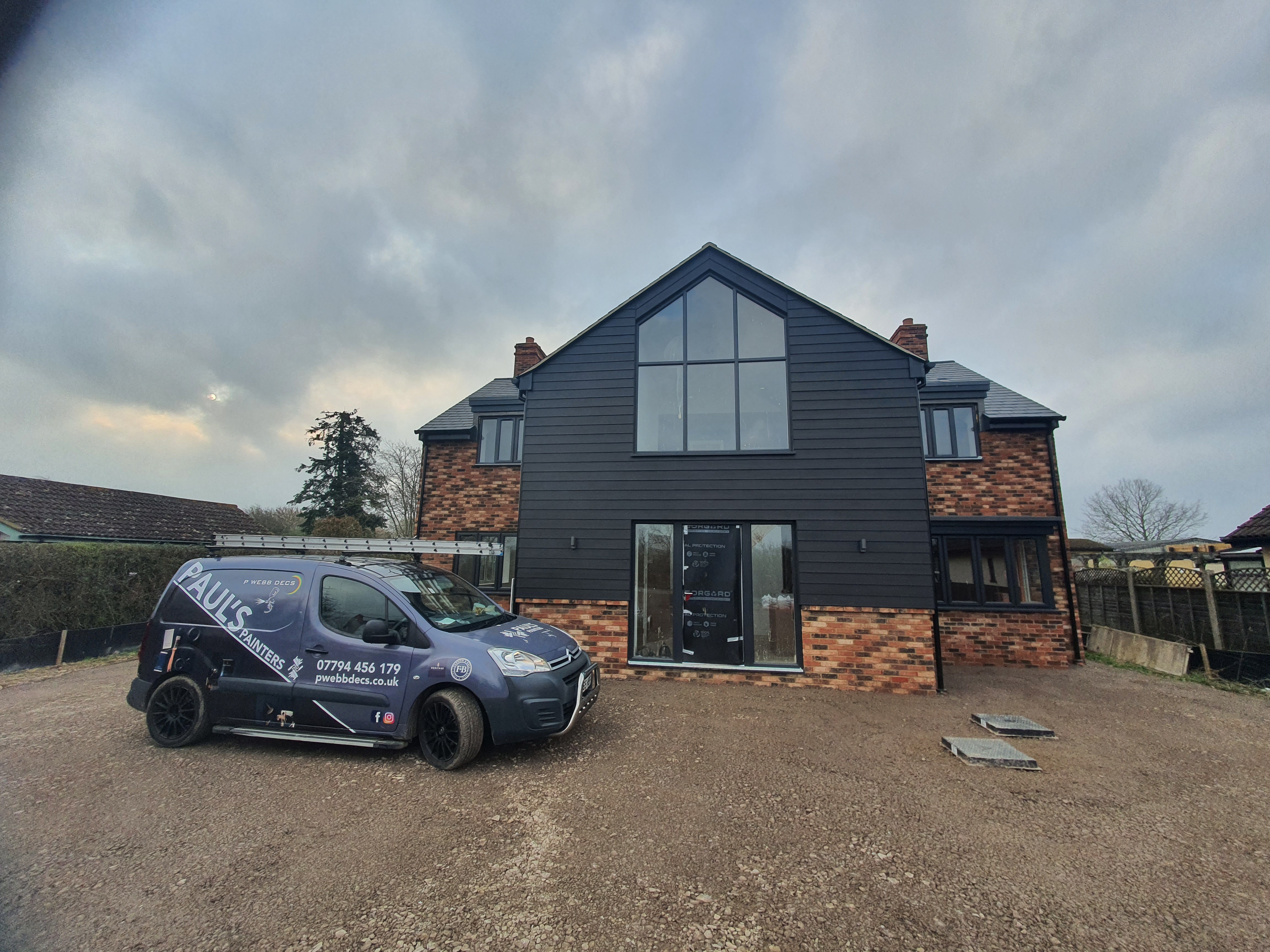 Paul's Painters van on-site — exterior cladding project Milton Keynes