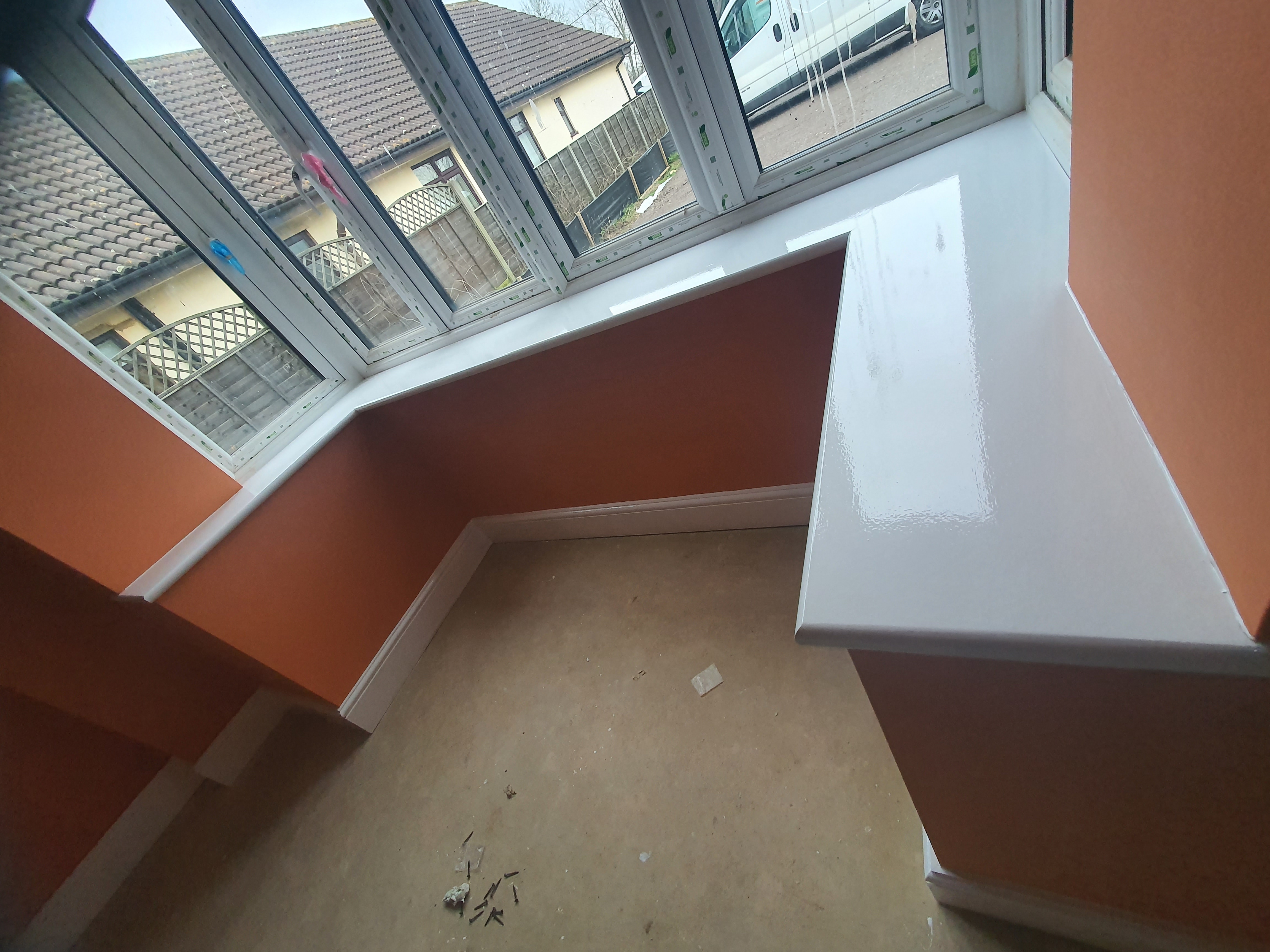 Interior room painting — terracotta walls with white gloss skirting
