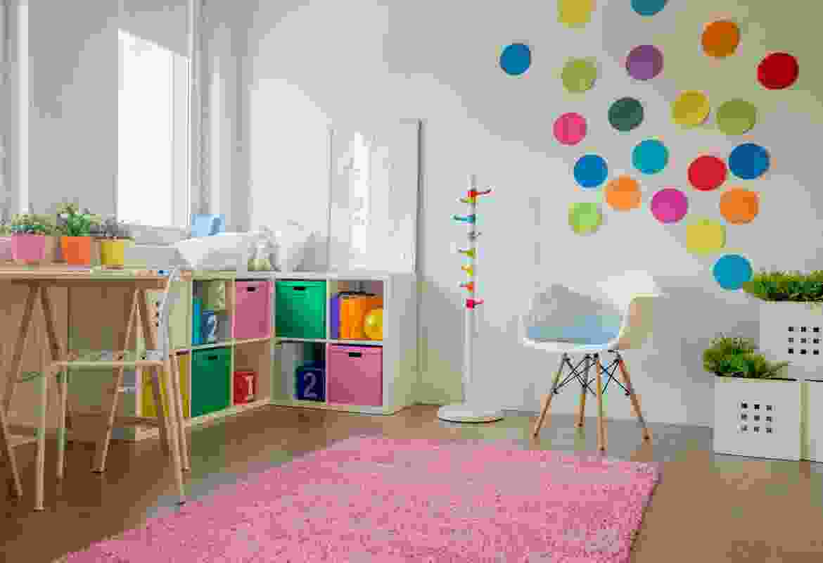 A child's room with colorful polka dots on the wall.