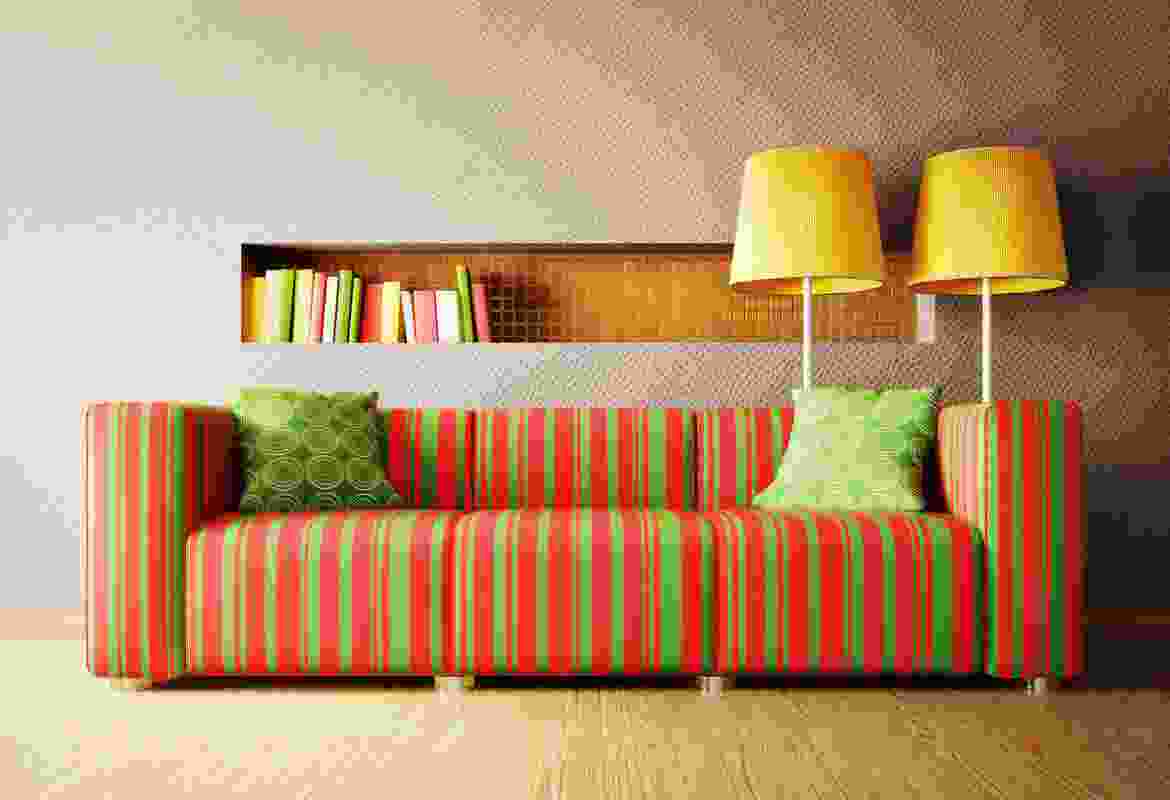 A colorful striped couch in a room.