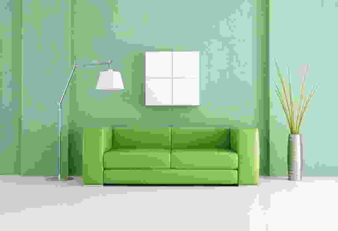 A green couch in a room.