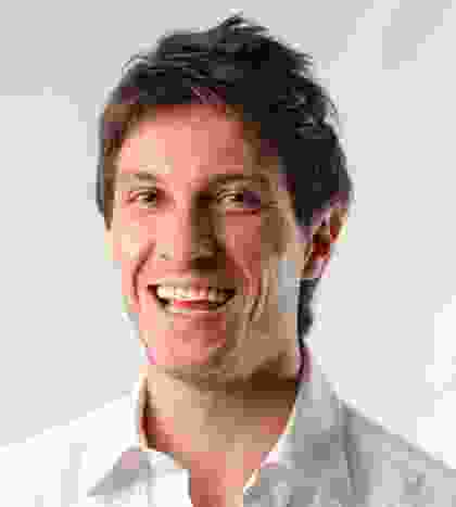 A smiling man in a white shirt.