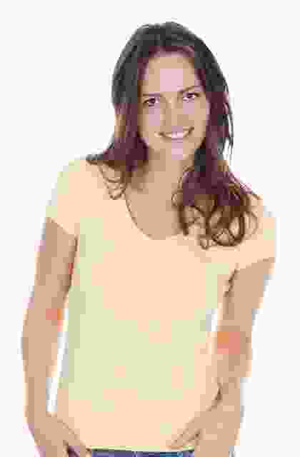 A woman in a yellow t - shirt posing for a photo.