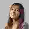 A woman with long hair and a smile on her face.