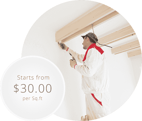 A man is painting the ceiling of a room.