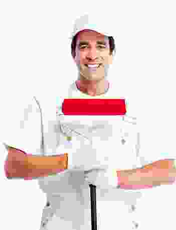 A man holding a paint brush in front of a white background.