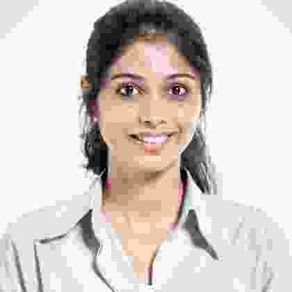 A smiling woman in a white shirt.