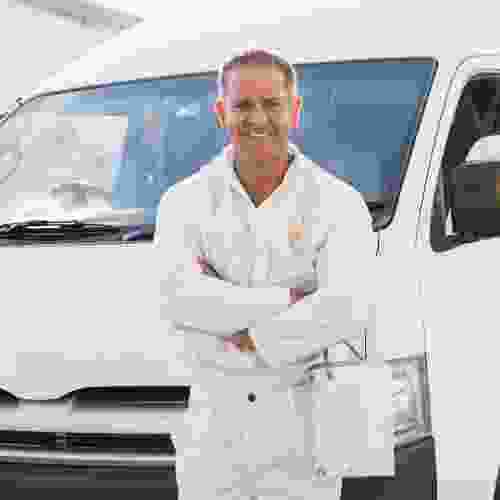 A man standing in front of a white van.
