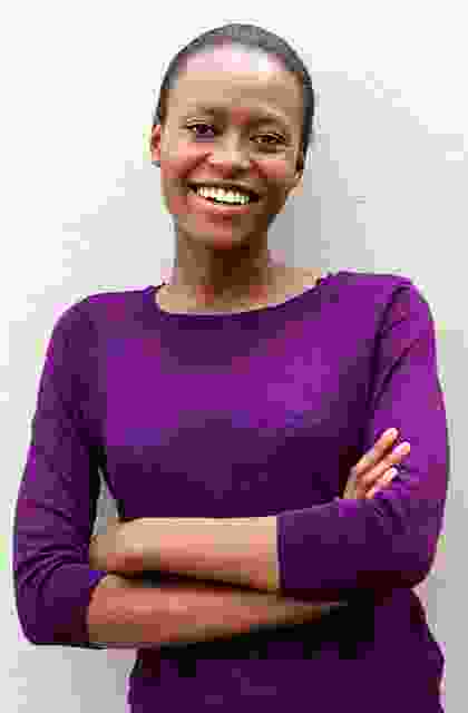 A woman in a purple shirt with her arms crossed.
