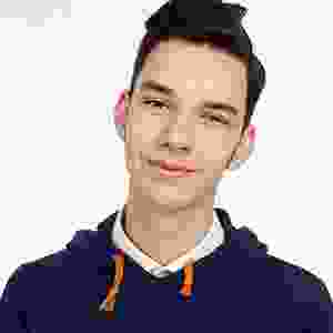 A young man in a blue hoodie posing for a photo.