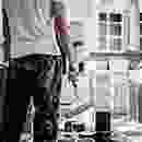 A black and white photo of a man standing in a kitchen.