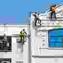 A picture of a building with people on top of it.