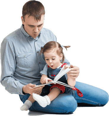 A man reading a book to his daughter.