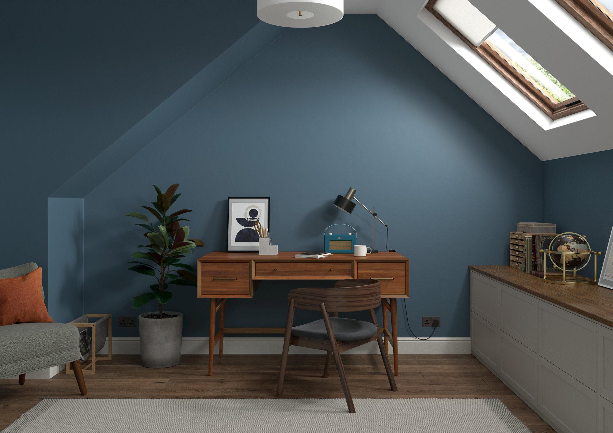An attic room with a desk and chair.