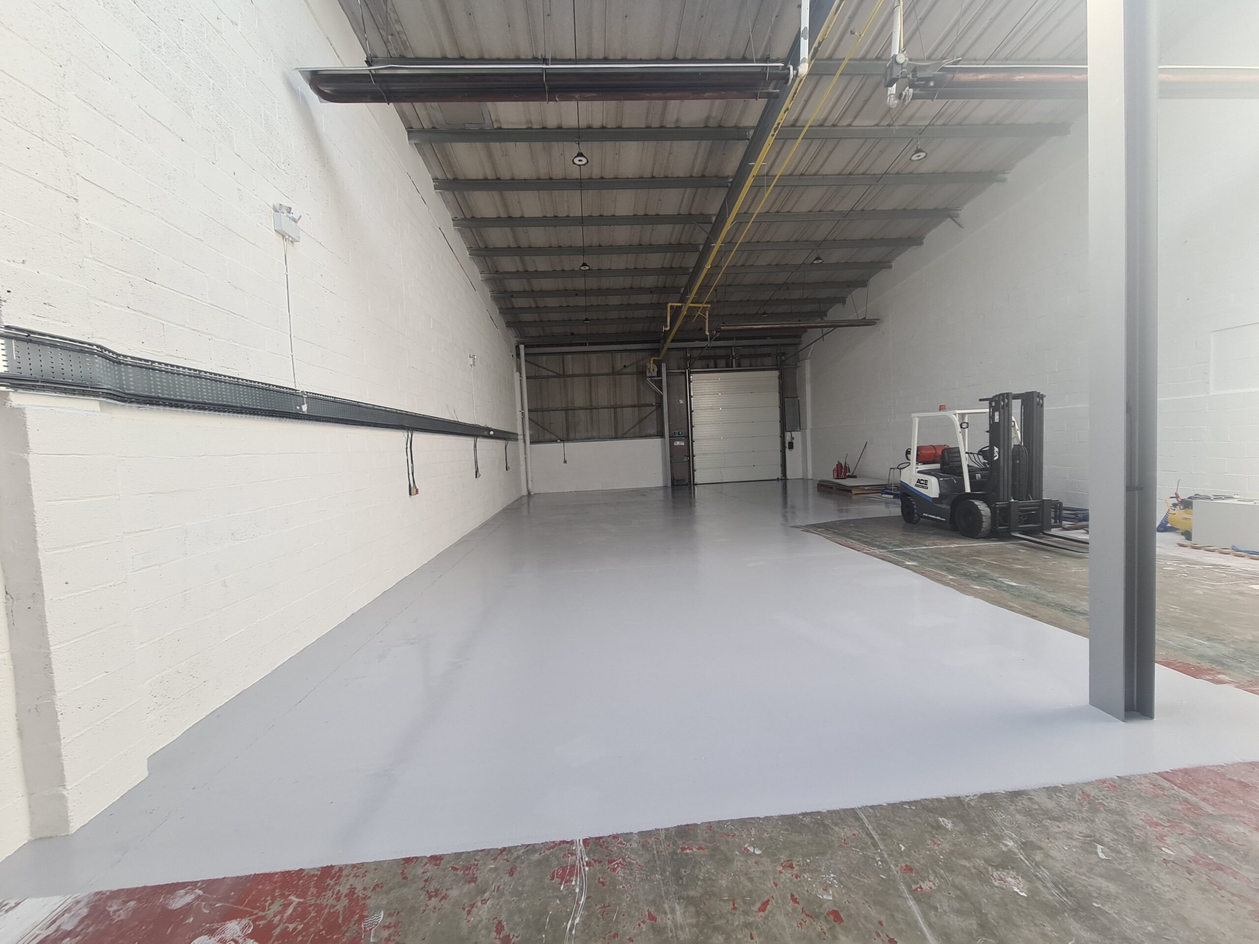 A warehouse with a white floor and white walls.