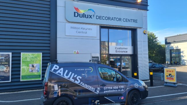 A van parked in front of a dulux decorator centre.