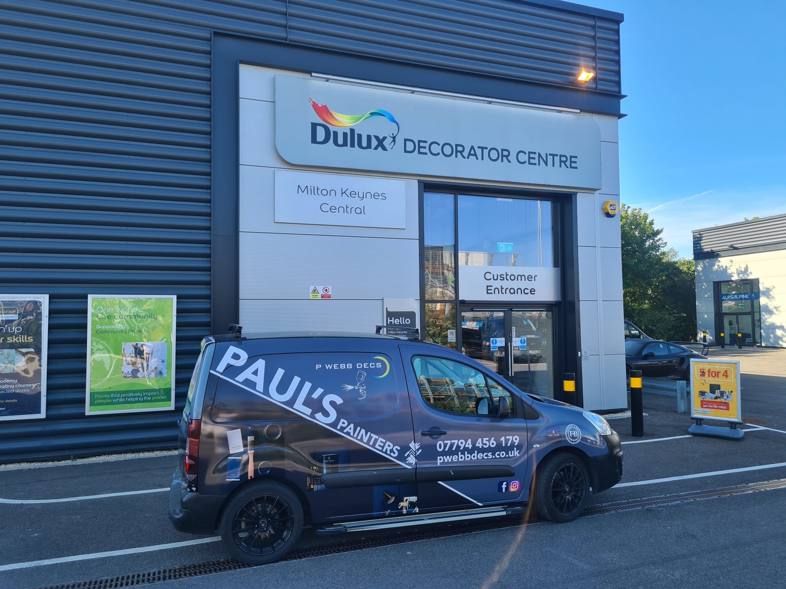 A van parked in front of a dulux decorator centre.