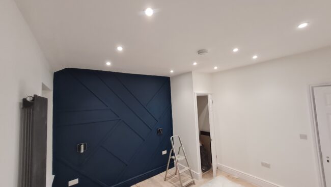 A room with a blue wall and white walls