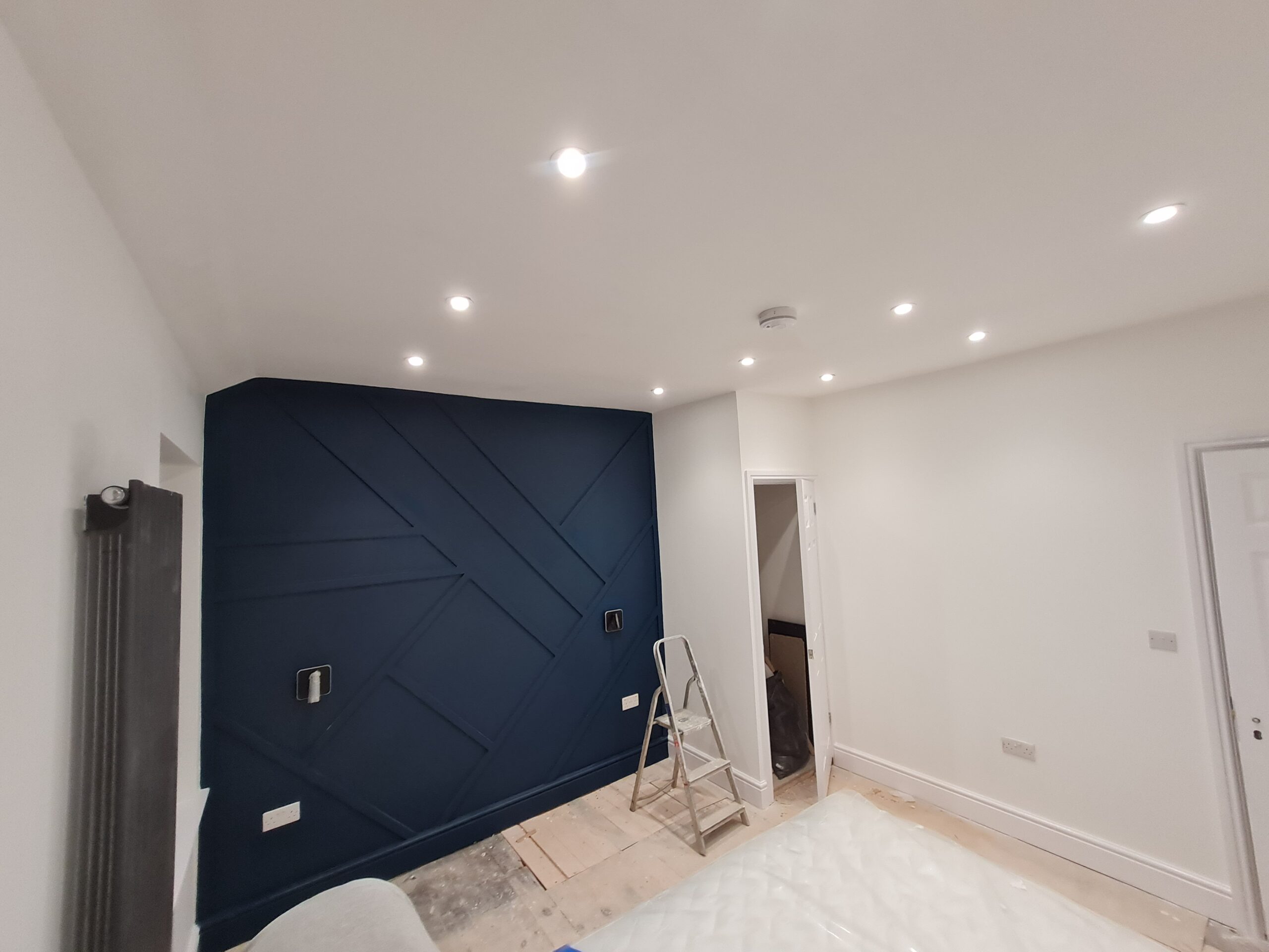 A room with a blue wall and white walls