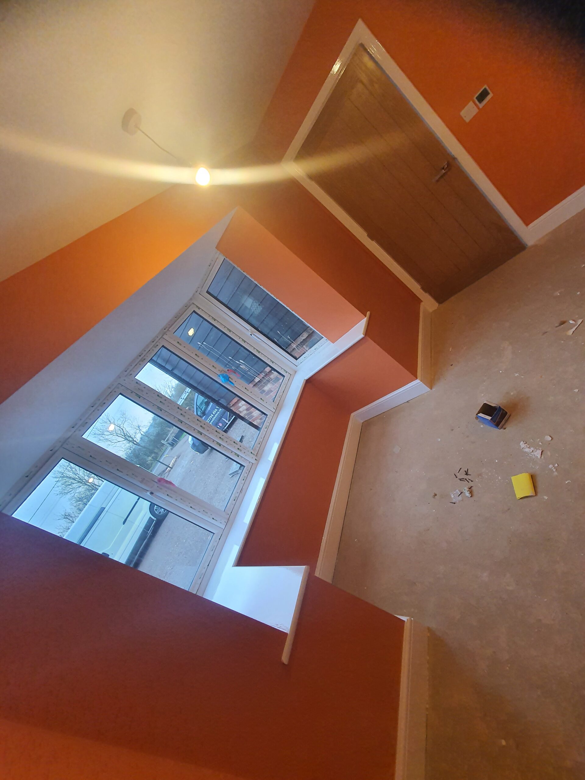 A room with orange walls and white trim.