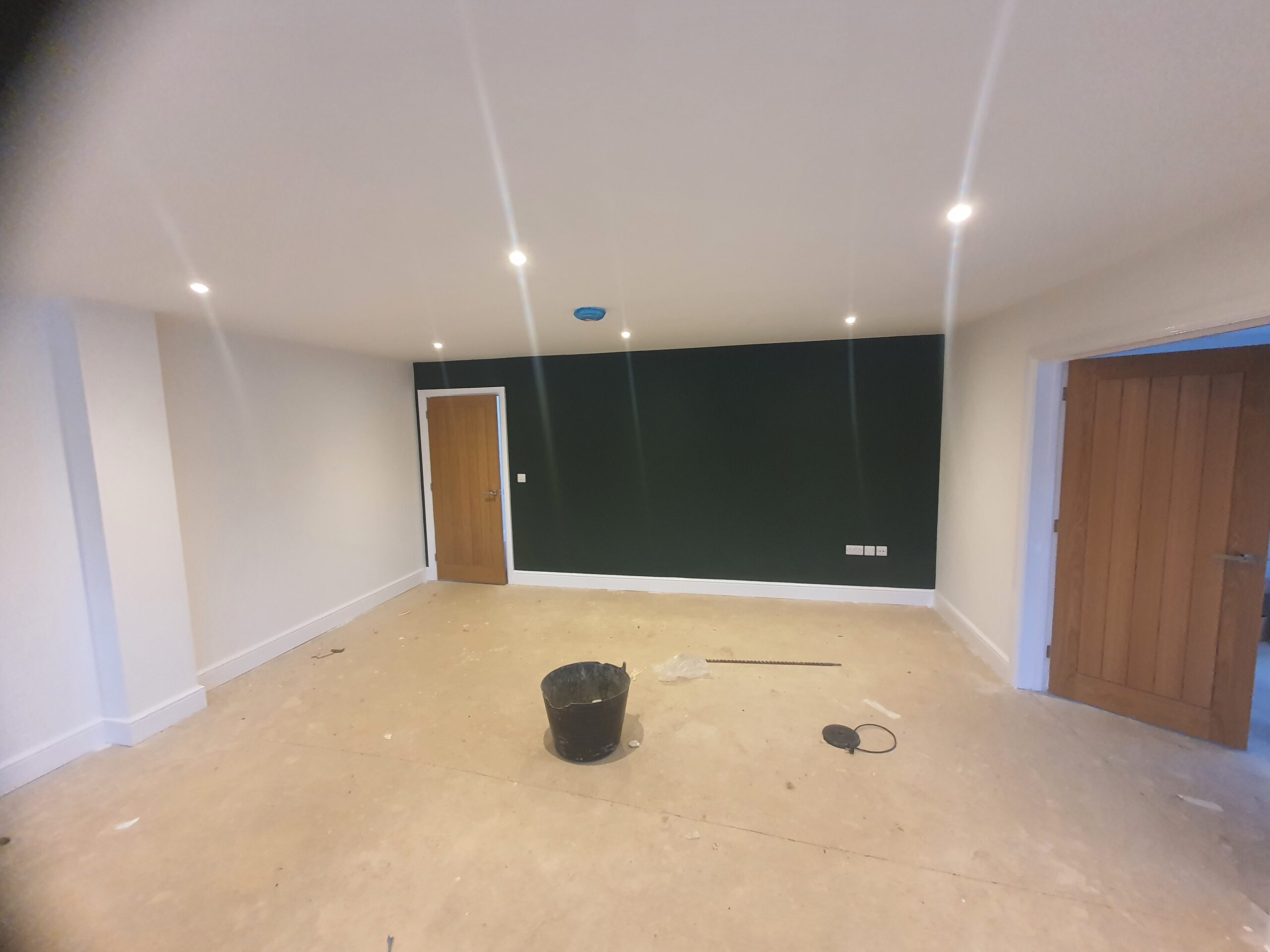 A room with a black wall and white walls