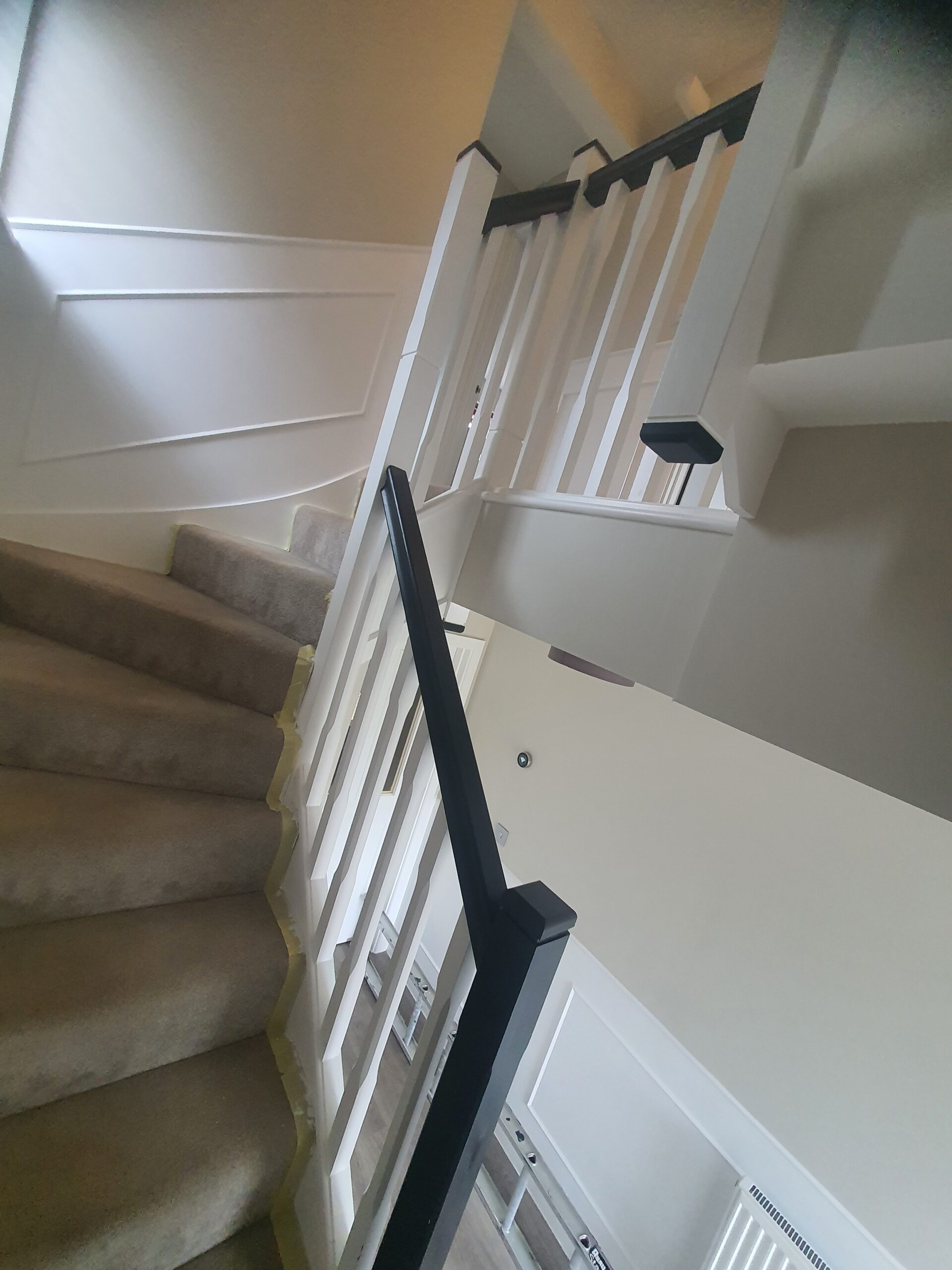 A view of the bottom half of stairs.