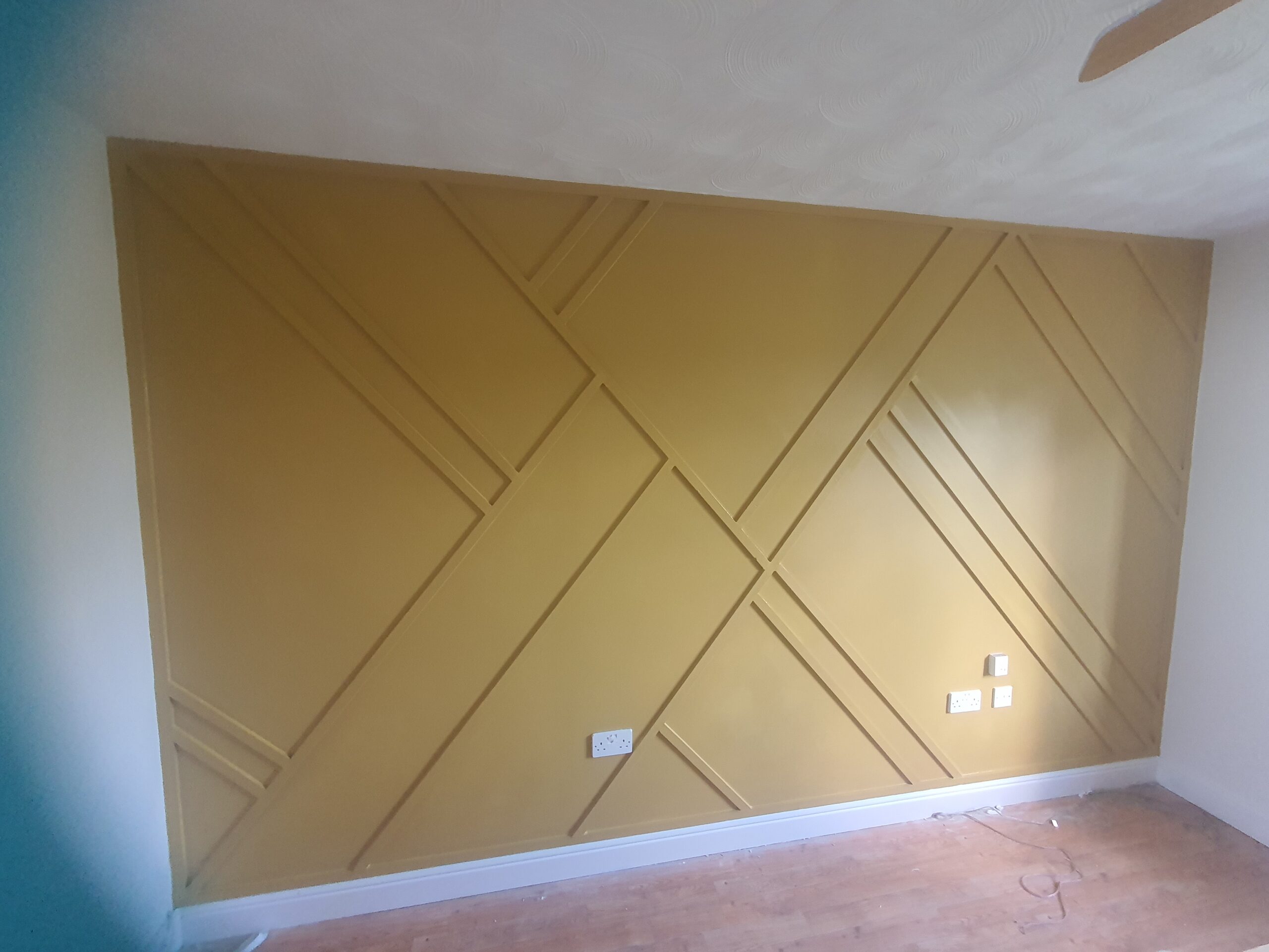 A wall with some yellow paint on it