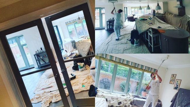 A man is painting a room in a house.