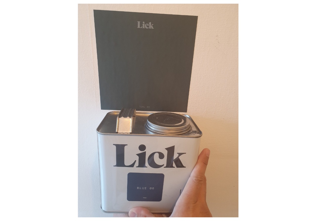 A person holding a tin with the word lick on it.