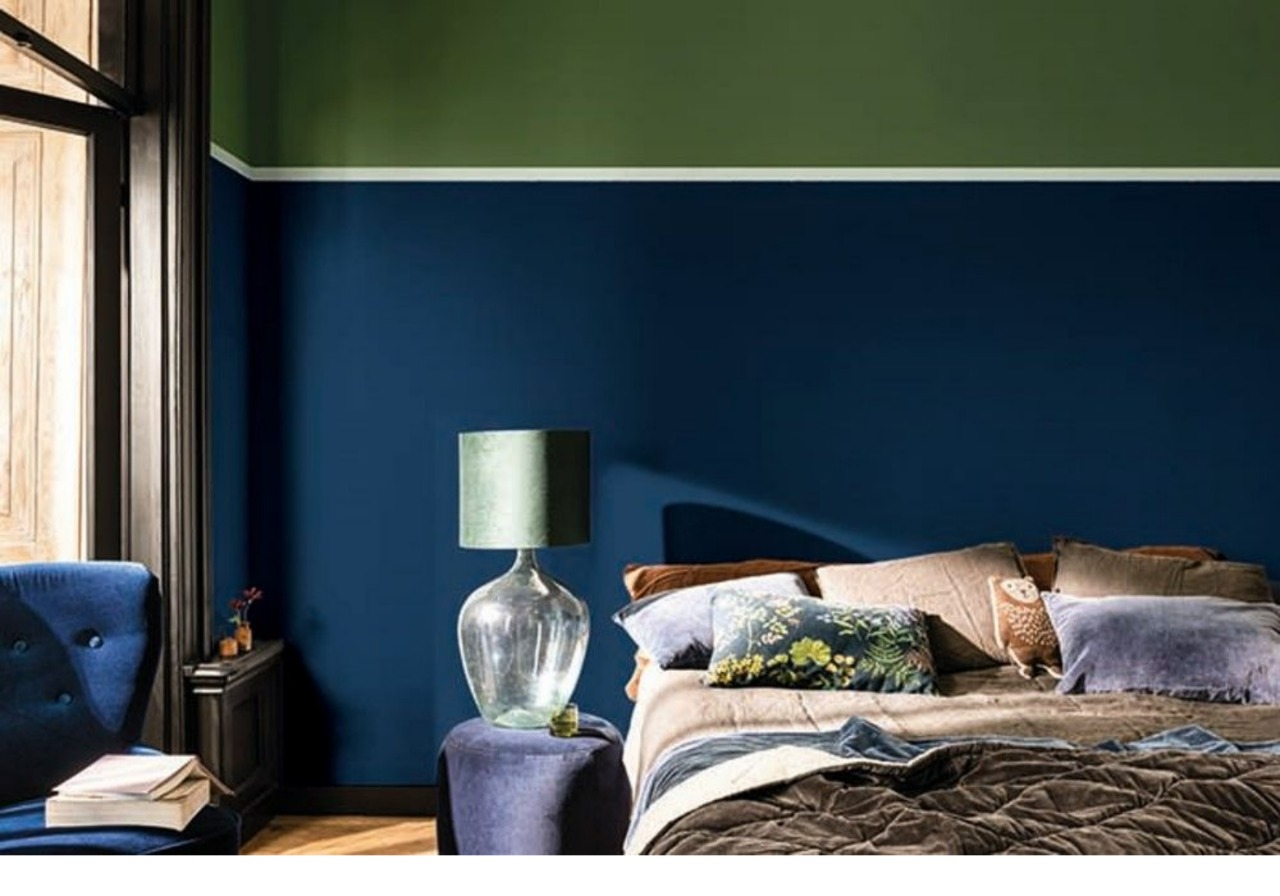 A bedroom with a blue and green color scheme.