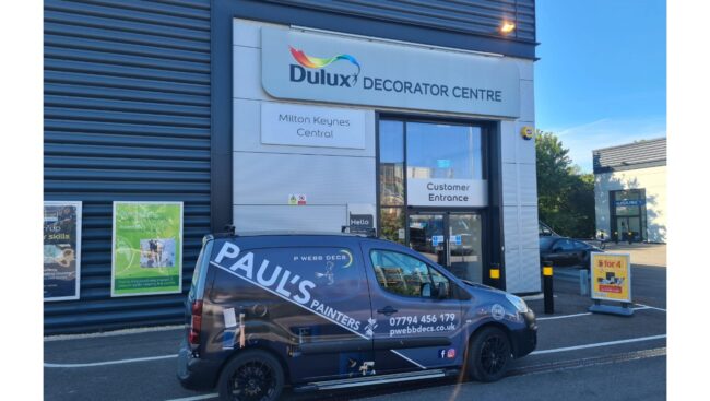 A van parked in front of a store.