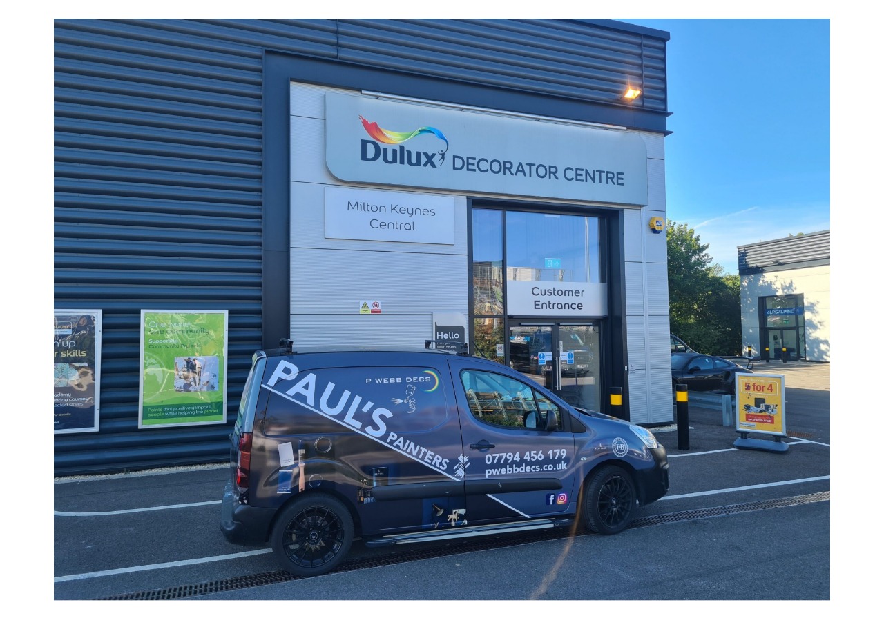 A van parked in front of a store.