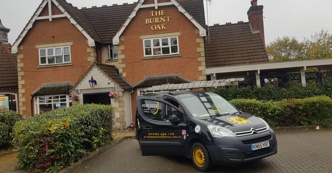 A van parked in front of a brick building.