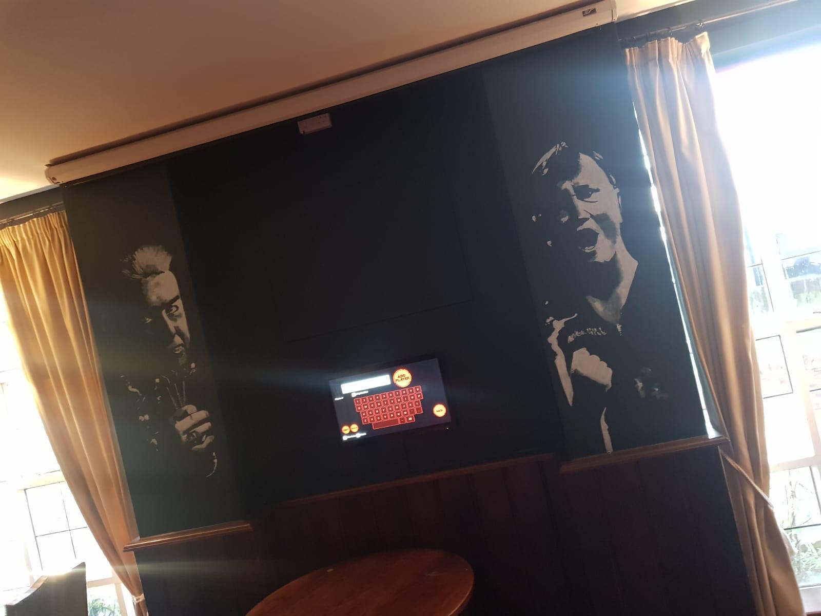 A room with black and white pictures on the wall.