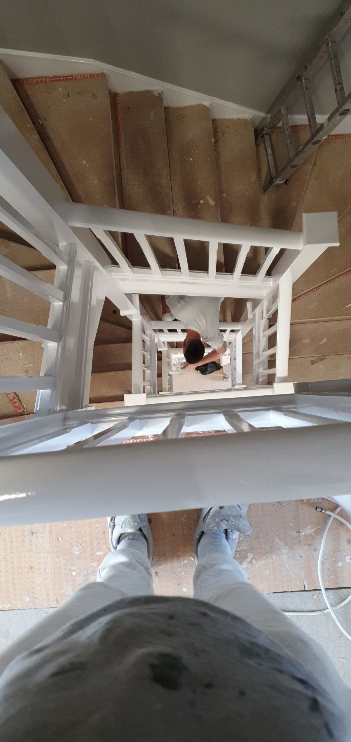A person is standing on a white staircase.