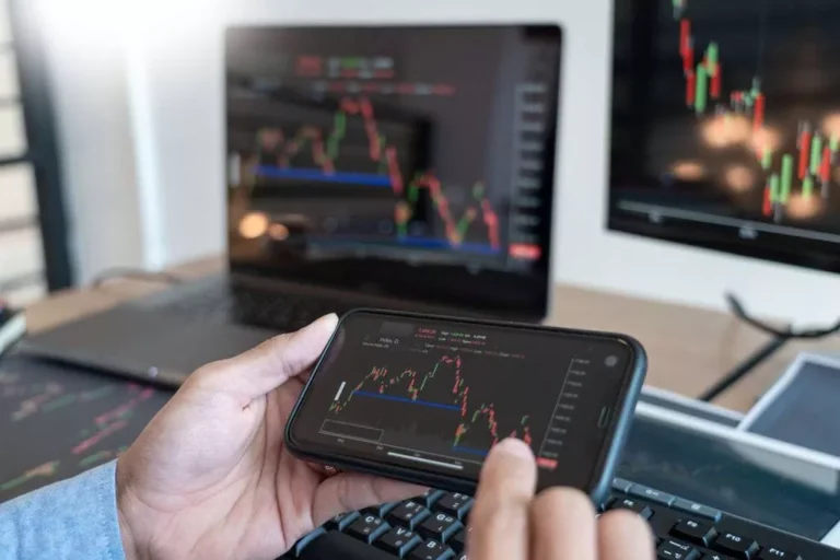Person analyzing stock charts on smartphone.